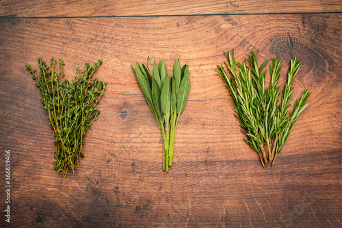 Thyme, Sage and Rosemary on a wooden table