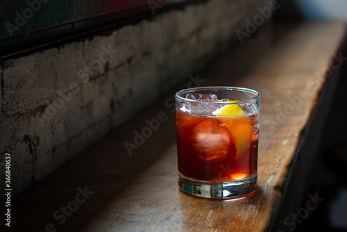 Red cocktail served on table