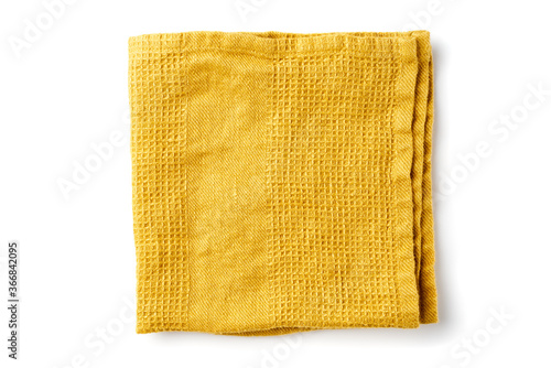 Folded yellow textile napkin on white