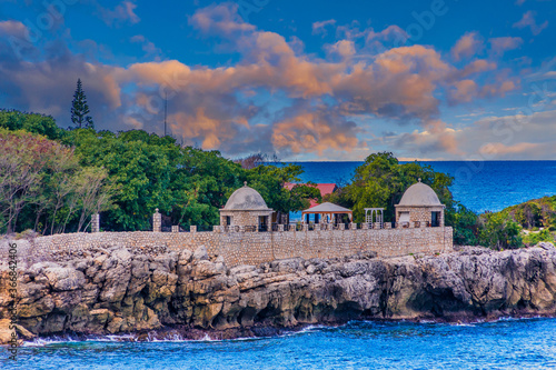 Fotografija A stone wall and observation points over the sea on the coast of Haiti