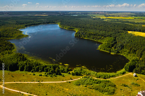 Top view of Bolta lake in the forest in the Braslav lakes National Park at dawn, the most beautiful places in Belarus.An island in the lake.Belarus. photo