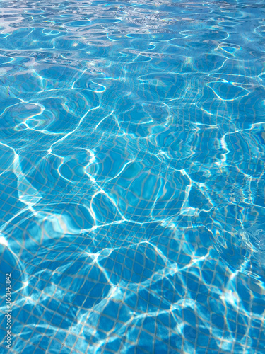 Top view of pool water, sunny bunnies, waves on water, blue background with water