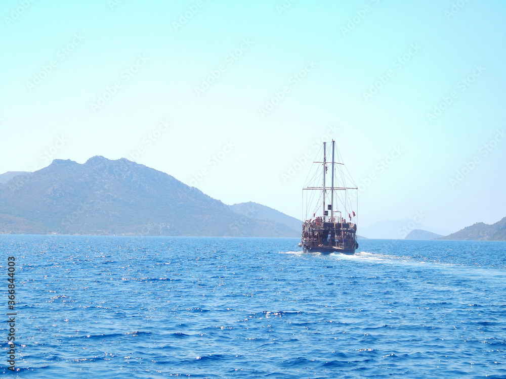 Pirate ship sails the sea, landscape, mountains