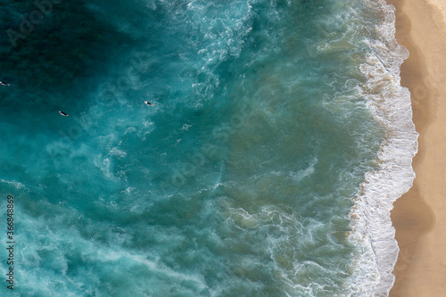 Aerial view of surfers paddling out in a rip at Bronte Beach in Sydney Australia 