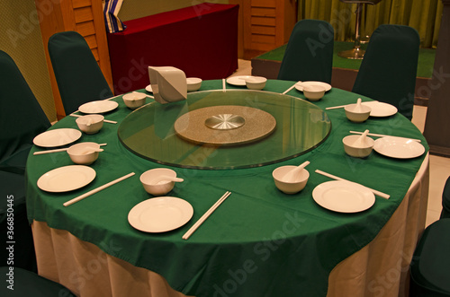 White dishes and cups on green table for Chinese food surving photo