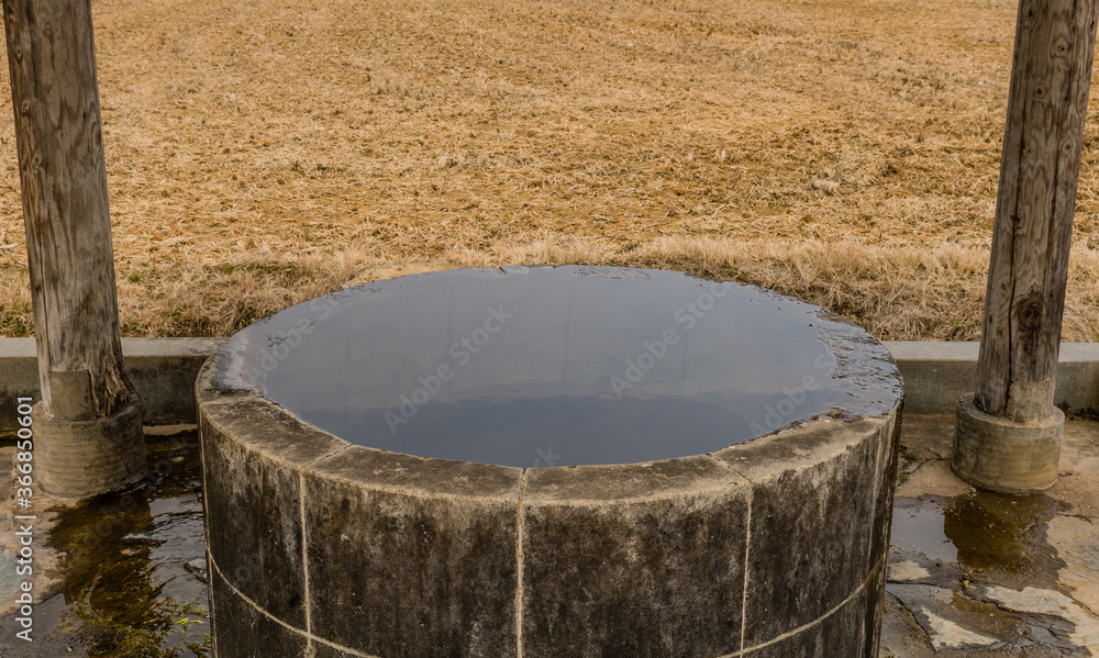 Old water well filled with water