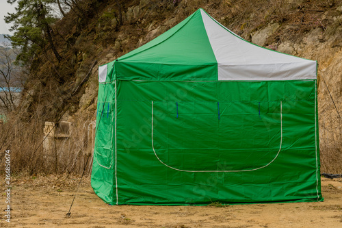 Green and white canvas tent