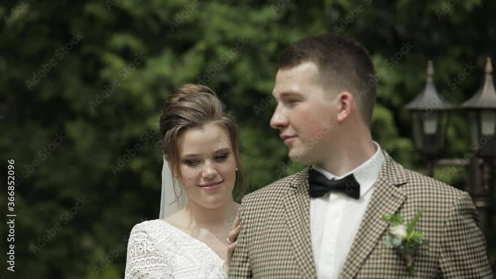 Newlyweds. Caucasian groom with bride walking in park. Wedding couple. Man and woman in love Newlyweds. Caucasian groom with bride walking in park. Wedding couple. Man and woman in love