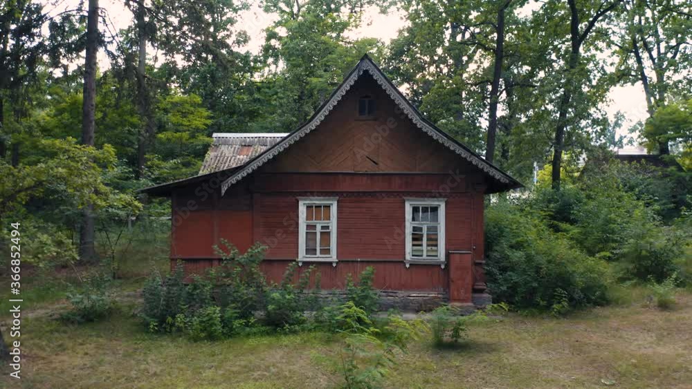 Abandoned wooden house (timber house) in a green forest. Aerial low angle view Abandoned wooden house (timber house) in a green forest. Aerial low angle view