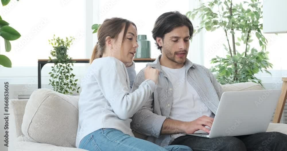 Couple planning and online shopping using laptop at home