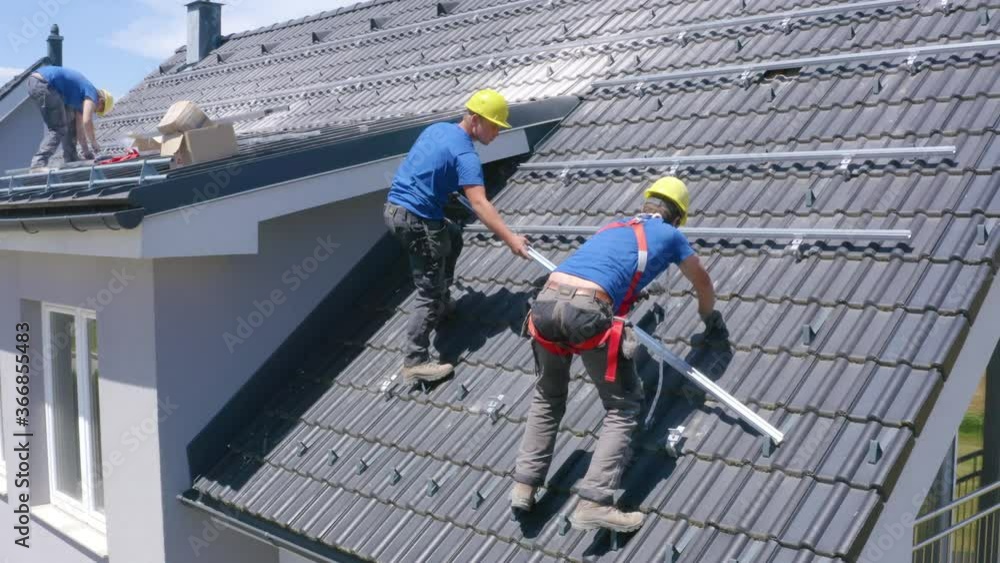 Constructions Workers Placing Railings On Roof Of House. Aerial View Constructions Workers Placing Railings On Roof Of House. Aerial View