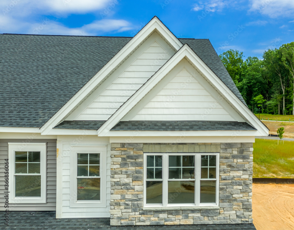 Double gable roof with manufactured stone veneer siding