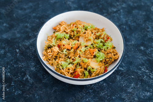 plant-based food, vegan ginger noodles with stir fry vegetables and grated celeri