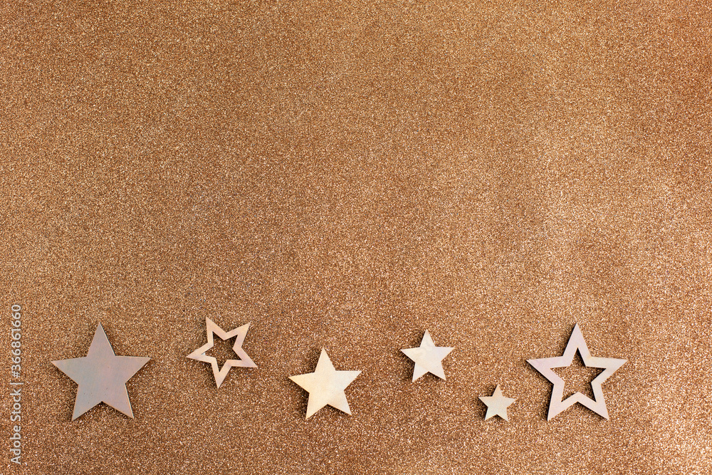 Rose gold stars and glitter on light brown background Rose gold stars and glitter on light brown background