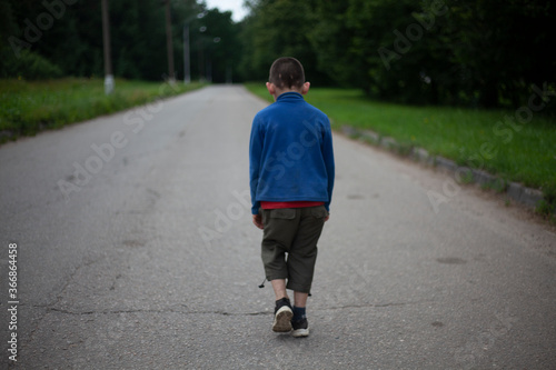 The child is alone on the road.