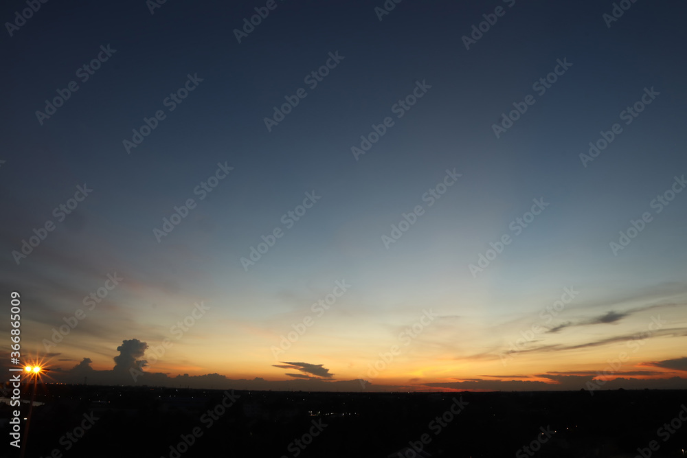 Dramatic atmosphere panorama aerial view of beautiful freshness summer twilight sky background at countryside of Thailand with shiny light and silhouette landscape.