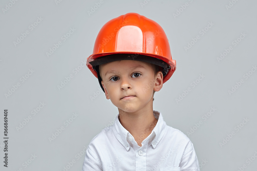 little boy in a construction helmet. advertising concept for the construction little boy in a construction helmet. advertising concept for the construction