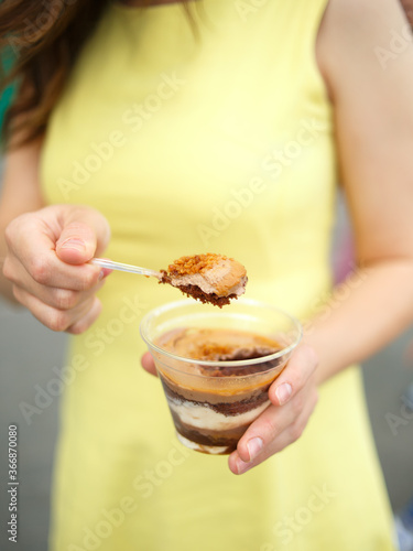 girl holding a delicious dessert with mousse and condensed milk
