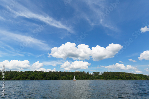 Fototapeta Naklejka Na Ścianę i Meble -  Lake in Polish Masuria on a sunny day. Picturesque cloudy sky, Masurian Lakeland, Poland