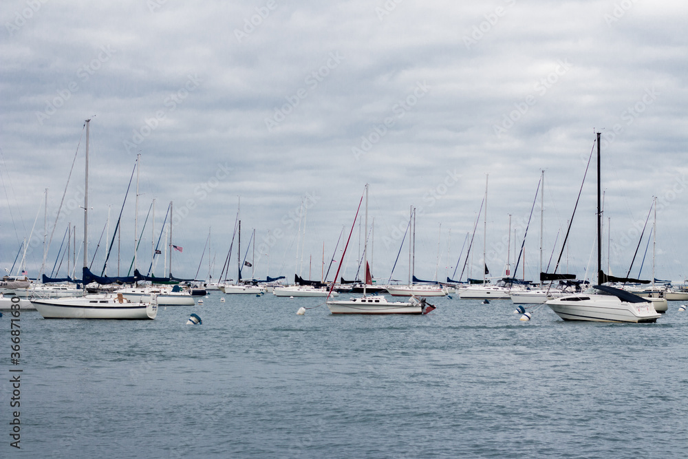 sailboats in the harbor on a lake during the day  discover my wall art prints at www.capturedbykeppford.com