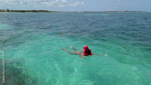 Young woman in the waters of Juanillo Beach snorkeling photo