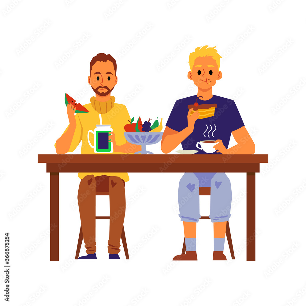 Two men eating food sitting behind table, people having lunch together Two men eating food sitting behind table, people having lunch together