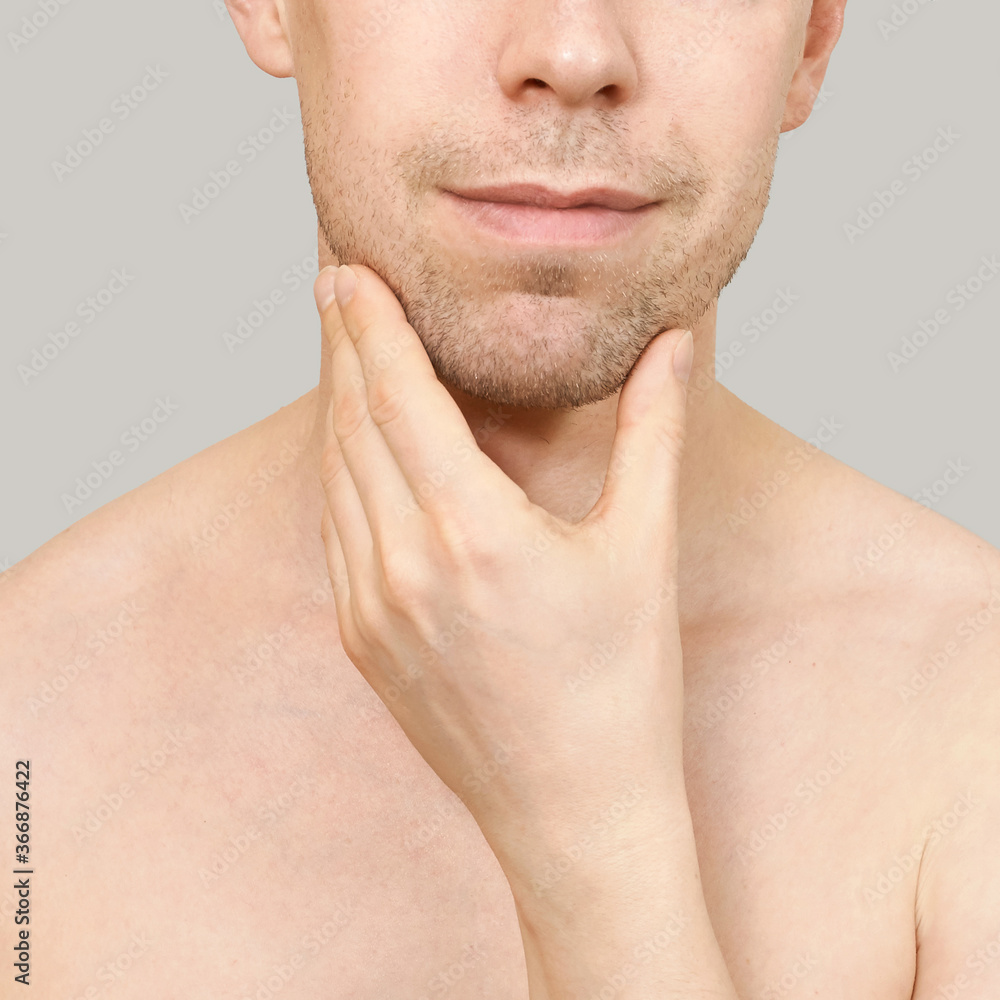 Man hold chin. Hand near male face. Think concept. Happy person. Close up. Casual home skin care routine. Healthcare facial treatment. Cute people standing. Mirror interesting Man hold chin. Hand near male face. Think concept. Happy person. Close up. Casual home skin care routine. Healthcare facial treatment. Cute people standing. Mirror interesting