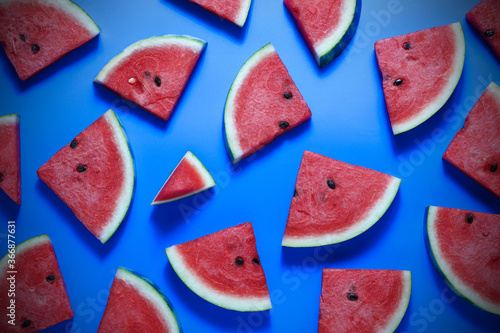 Top view, flat lay watermelon slice fruits on blue wooden table background.