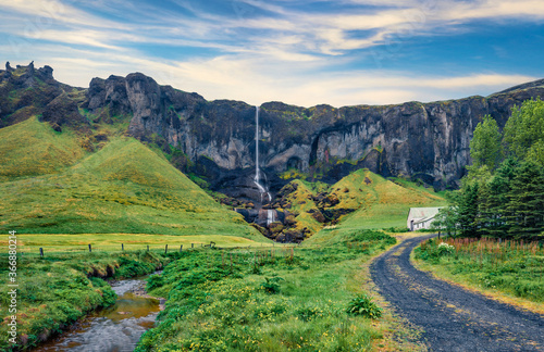 Fresh green scene of Foss a Sidu Waterfall. Wonderful morning view of Iceland, Europe. Picturesque landscape of countryside. Traveling concept background..