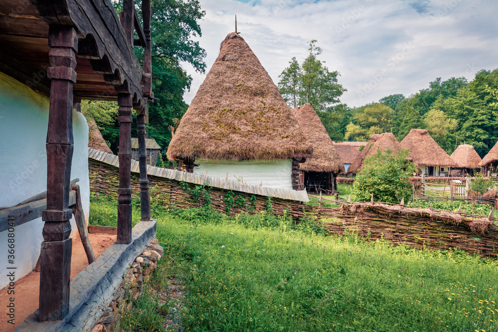 Splendid summer view of traditional romanian peasant houses. Beautiful rural scene of Transylvania, Romania, Europe. Traveling concept background..