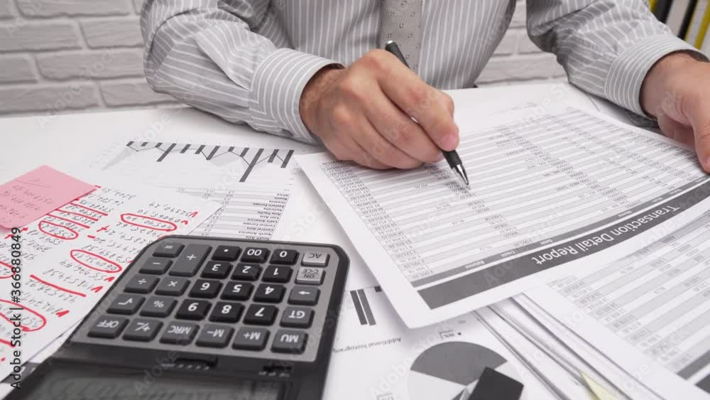 Business analysis and accounting concept - businessman working with document, spreadsheet, using calculator, tablet pc. Office desk closeup. Business analysis and accounting concept - businessman working with document, spreadsheet, using calculator, tablet pc. Office desk closeup.