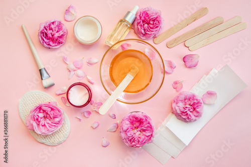 beauty, depilation and hair removal concept - wax with spatula, epilator and safety razor on pink background