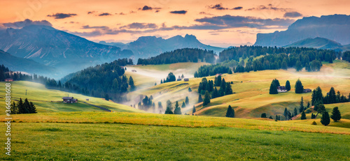 Panoramic morning scene of Compaccio village, Seiser Alm or Alpe di Siusi location, Bolzano province, South Tyrol, Italy, Europe. Fabulous summer sunrise of Dolomiti Alps. © Andrew Mayovskyy