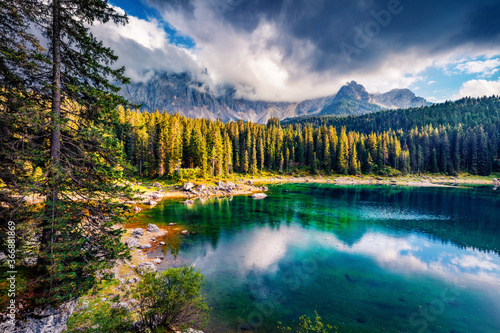 Spectacular summer view of Carezza (Karersee) lake. Magnificent morning scene of Dolomiti Alps, Province of Bolzano, South Tyrol, Italy, Europe. Beauty of nature concept background.