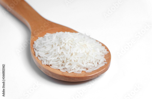 Polished white rice in wooden spoon.