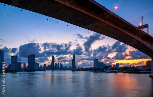 bangkok sunrise cityscape with chao praya river and high bridge for transportation