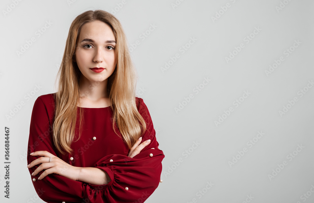 Fototapeta premium Young carefree modern girl with long blonde hairs in casual light clothes posing isolated on white wall background. People lifestyle concept. Copy space for your text