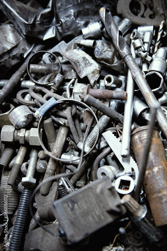 A box with piles of used screws and metal pieces. © Anna