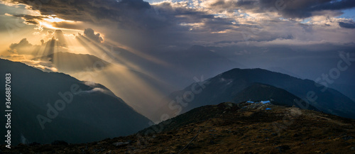 Panorama of hills and mountains with beam of lights during sunset at Lauribinayak, on the way to Gosainkunda lakes in Langtang National Park, Nepal.