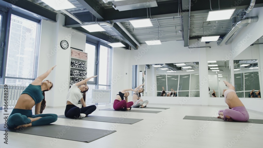 Fototapeta premium Group of people doing starting exercise with a coach