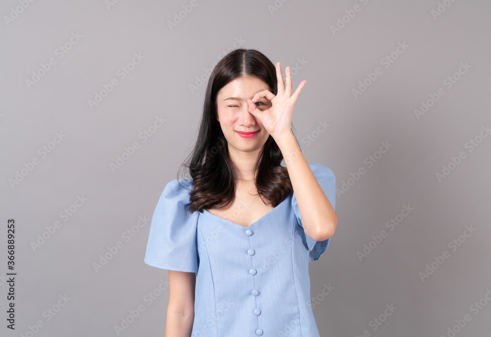 Young asian woman with okay hand sign