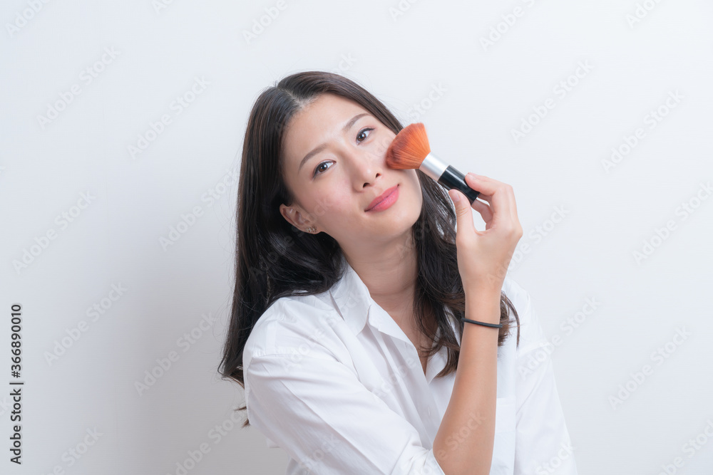 Beautiful Young Female Model Putting Blush With Cosmetic Brush Beautiful Young Female Model Putting Blush With Cosmetic Brush