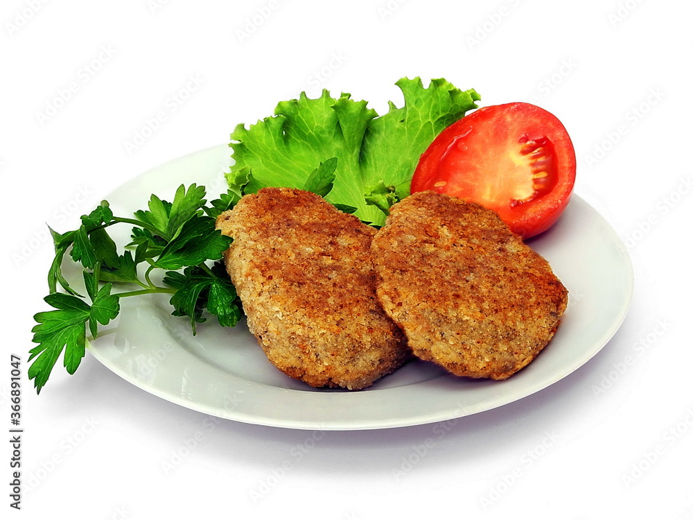 Meat cutlet with vegetables on a plate. Isolate on white.