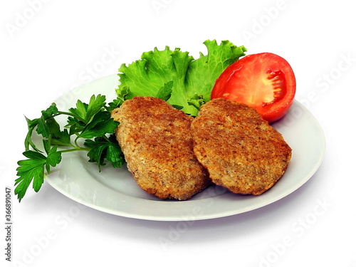 Meat cutlet with vegetables on a plate. Isolate on white.