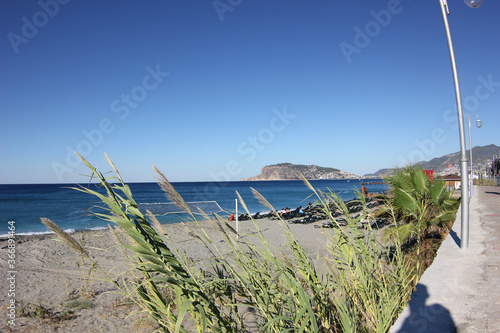 Fototapeta Naklejka Na Ścianę i Meble -  Alanya, TURKEY - August 10, 2013: Travel to Turkey. Beaches on the sea. Waves on the Mediterranean coast.