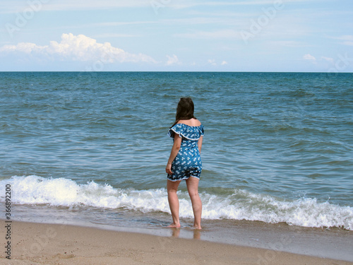 Girl walks along the shore