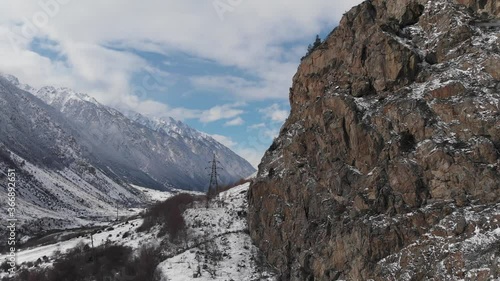 Wallpaper Mural Aerial view flight in a mountain gorge near the cliffs in the afternoon. Approaching the support of the high voltage electric transmission line. Torontodigital.ca