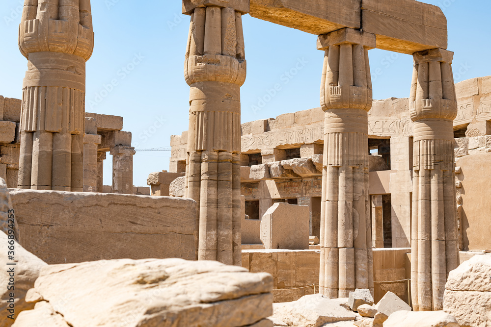 LUXOR, EGYPT - FEBRUARY 28, 2020:  Selective focus of ruins of Karnak temple with blue sky at background