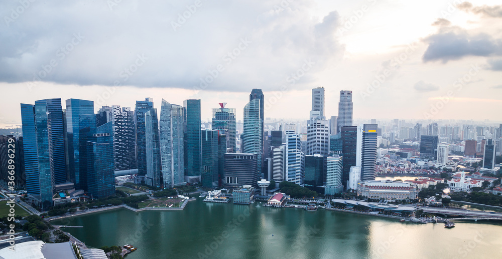 Singapore sunset view panoramic banner. Modern skyscrapers and skyline of business district Marina Bay Sands at developing Asian city. Travel, background, landmark concept