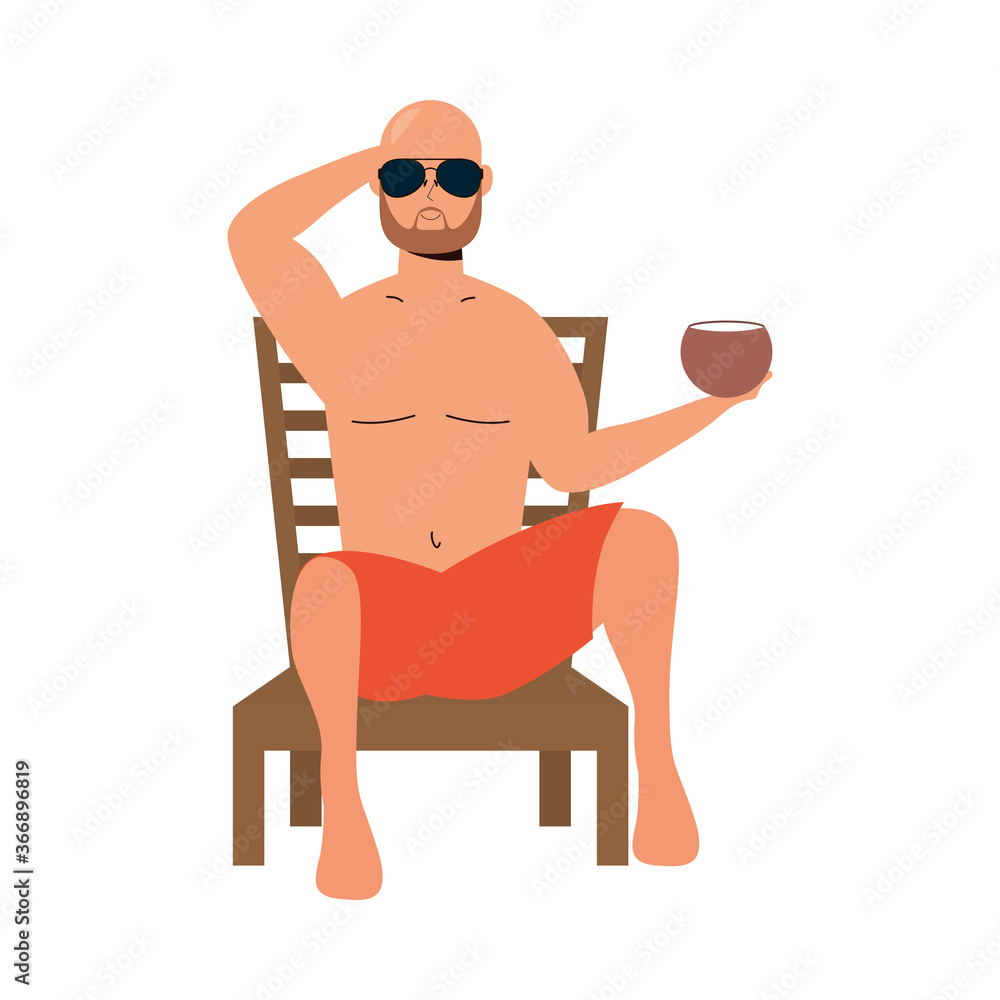 man wearing swimsuit seated in beach chair eating coconut